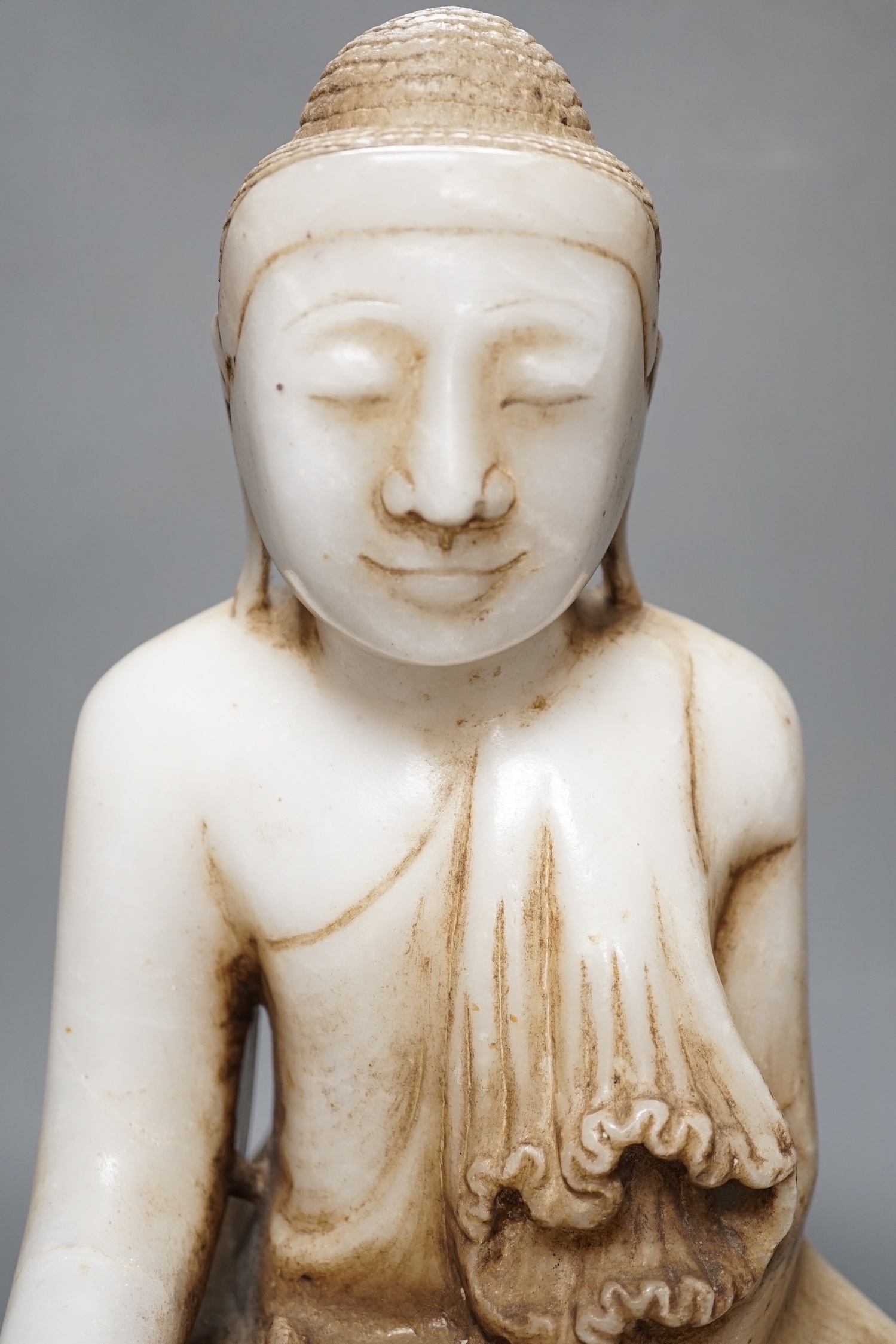 A Burmese carved marble seated Buddha on lotus throne, 20th century - 39cm high